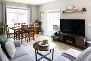 a living room with a couch and a tv and a table at The Mackenzie Haven in Revelstoke