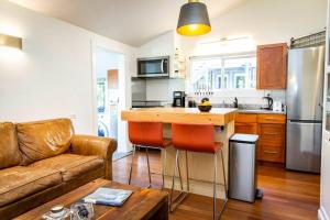 a kitchen with a couch and a table in a room at The Revelstuck Hut - Downtown Revelstoke in Revelstoke