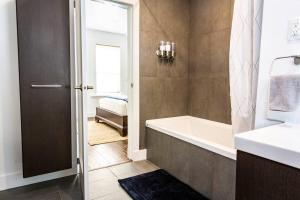 a bathroom with a bath tub and a sink at The Revelstuck Hut - Downtown Revelstoke in Revelstoke