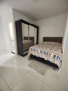 a bedroom with a bed and a large mirror at Casa Lenger in Aracaju