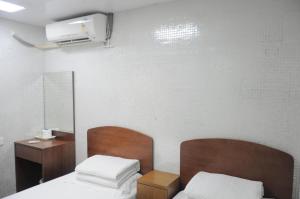מיטה או מיטות בחדר ב-Jinhai Hotel