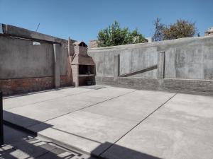 a concrete wall with a concrete floor and a brick oven at Casa Obrien in Barraquero