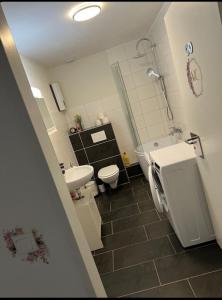 a bathroom with a sink and a toilet and a shower at Las Vegas by D&J Apartment‘s in Oberhausen