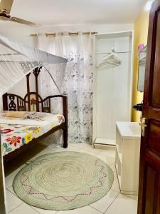 a bedroom with a bed and a shower and a rug at Kelele Square in Zanzibar City