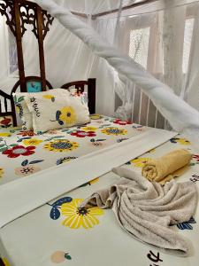 a bedroom with two beds with flowers on them at Kelele Square in Zanzibar City