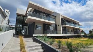 a large house with stairs in front of it at Balcón Edén Apart in La Falda
