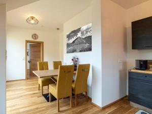 a kitchen and dining room with a table and chairs at Flat in Hohentauern near the ski area in Hohentauern