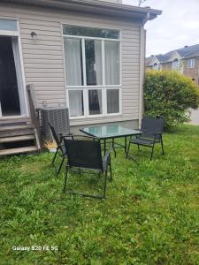 a patio with two chairs and a glass table in the yard at Private Room 2 in Ottawa