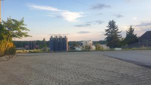 an empty parking lot with a brick road at fine quiet studio in Möriken-Wildegg