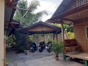 a group of motorcycles parked under a building at Alimpay Foresters Apartment in Panglao