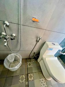 a bathroom with a toilet and a shower at NIRVANA HAVEN HOME STAY in Trivandrum