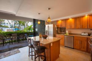 uma cozinha com uma ilha com uma bancada em Maui Parkshore 105 - MCH em Kihei