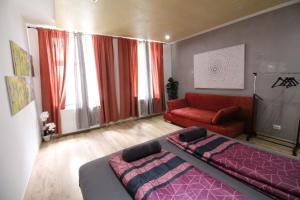 a bedroom with a bed and a red couch at Premium Triple room RF in Vienna