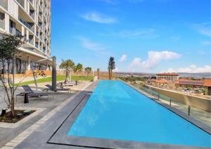 a swimming pool on the roof of a building at Luxury Haven at Ellipse Waterfall in Midrand