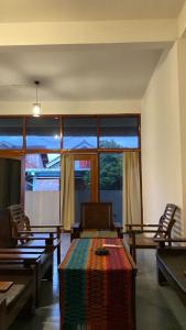 um quarto com mesas e cadeiras e uma grande janela em Gerupuk Homestay and Restaurant em Praya