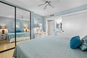 a bedroom with a large bed and a mirror at Sugar Beach 306 - MCH in Kihei