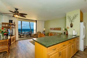 a kitchen and living room with a view of the ocean at Sugar Beach 334 - MCH in Kihei