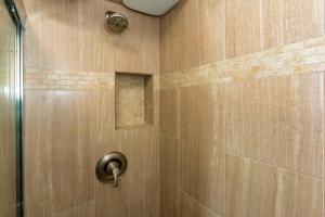 a shower with a wooden wall with a metal door at Sugar Beach 334 - MCH in Kihei +26 photos