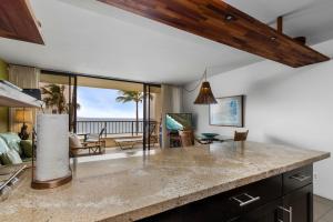 an open kitchen with a view of the ocean at Sugar Beach 416 - MCH in Kihei