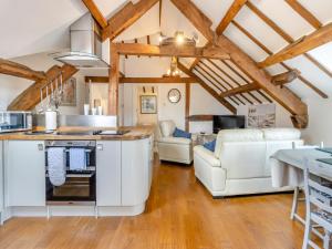 a kitchen and living room with wooden ceilings at Walkers Retreat - Uk45415 in Eaton Bishop
