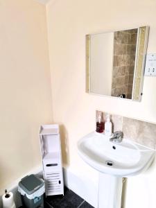 a bathroom with a sink and a mirror at Luxury house for 6 guests next to Anfield stadium in Liverpool