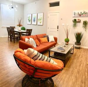 a living room with a couch and a table at NEW! Luxury Apt, 5 min from Mall, Airport, & Dine! in McAllen