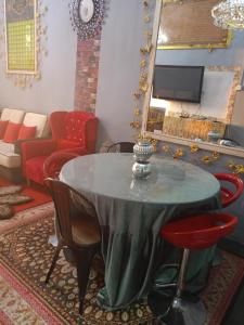 a living room with a table and chairs at Homestay ALHAQIM in Pontian Kecil