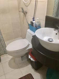 a bathroom with a toilet and a sink at Penthouse Cozy Room + Netflix Near at Venice Mall in Manila