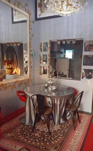 a dining room with a table and chairs and a fireplace at Homestay ALHAQIM in Pontian Kecil