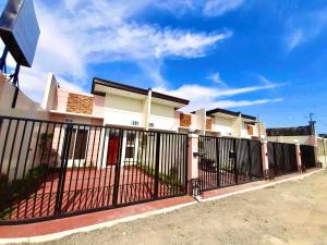 a black fence in front of a house at Lemoons Apartelle in Tagum