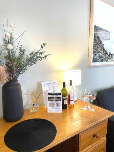 a table with two bottles of wine and glasses on it at City Heart Motel Warrnambool in Warrnambool