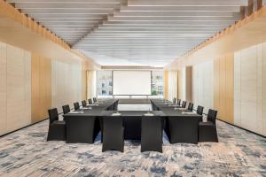 a conference room with a long table and chairs at The Westin Wuhan Hanyang in Wuhan