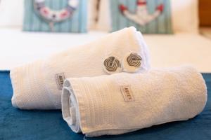 a towel with two rings on it sitting on a bed at Praia do Forte BAHIA in Praia do Forte