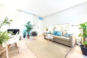 uma sala de estar com um sofá e algumas plantas em One bedroom appartement with wifi at Madrid em Madri