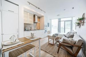 a kitchen and living room with a couch and a table at Downtown Toronto Gem in Toronto