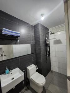 a bathroom with a white toilet and a sink at Klia Horizon Suite Kota Warisan in Sepang