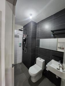 a bathroom with a toilet and a sink at Klia Horizon Suite Kota Warisan in Sepang