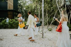 a group of people walking around in a park at K NAJ Community Tulum in Balcheil