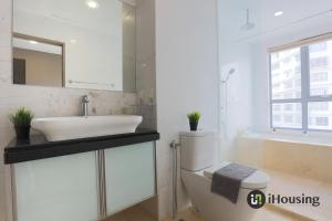 a bathroom with a sink and a toilet and a mirror at Silverscape Deluxe Melaka by I Housing in Melaka +287 photos
