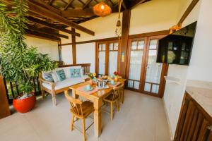 a dining room with a wooden table and chairs at Praia do Forte BAHIA in Praia do Forte