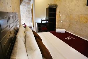 a bedroom with a large bed with pillows at Hoteles Riviera Colonial in Arequipa