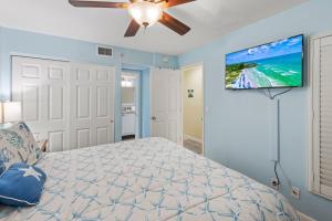 a bedroom with a bed and a ceiling fan at South Seas Beach Villa 2412 condo in Captiva