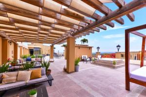 an outdoor patio with a wooden pergola and furniture at Krystal Grand Residences & Villas San Miguel de Allende in San Miguel de Allende