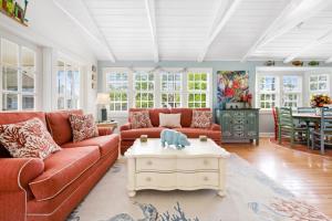 a living room with two couches and a coffee table at Turtle Cottage home in Captiva
