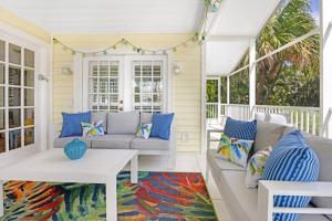 a porch with a couch and a table at Turtle Cottage home in Captiva