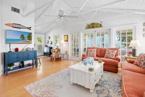 a living room with a couch and a table at Turtle Cottage home in Captiva