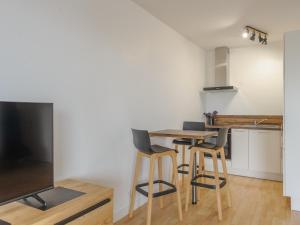 a kitchen and dining room with a table and chairs at Appartement Calme avec Grande Terrasse, Aytré, Proche Lac, 2 Pers. - FR-1-535-49 in Aytré