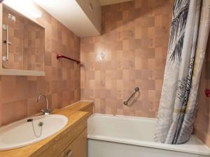 a bathroom with a sink and a tub and a shower at Chalet mitoyen avec terrasse et parking à Cauterets - FR-1-401-269 in Cauterets