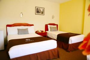 a hotel room with two beds in a room at Hoteles Riviera Cayma in Arequipa