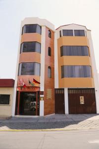 a tall building with a store in front of it at Hoteles Riviera Cayma in Arequipa